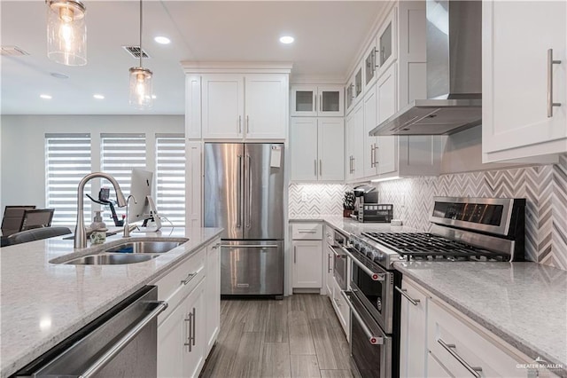 6907 N 11th Ln, Mcallen, TX 78504 - kitchen with wall chimney range hood, stainless steel appliances, white cabinets, and recessed lighting