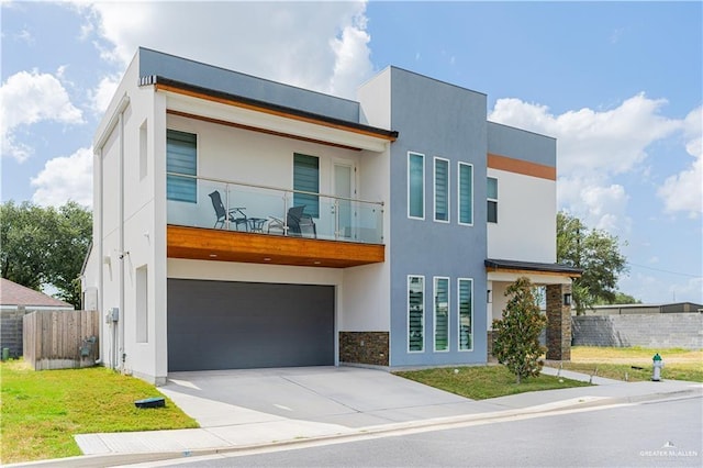 6907 N 11th Ln, Mcallen, TX 78504 - modern home featuring a balcony, an attached garage, stucco siding, driveway, and stone siding