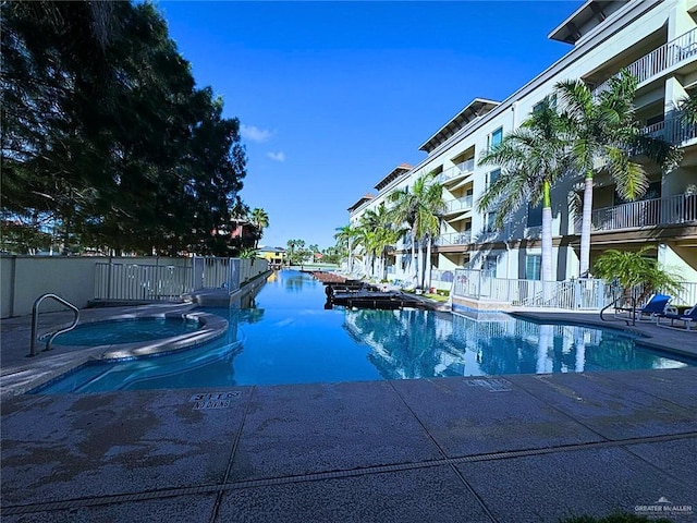 view of pool with a community hot tub