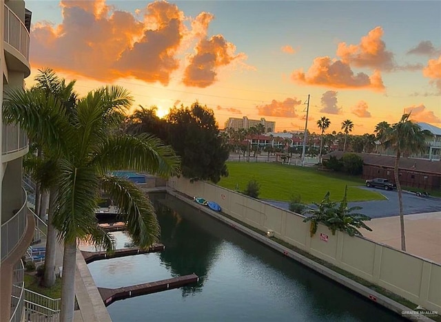 exterior space featuring a lawn and a water view