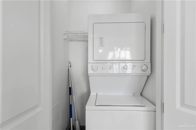 laundry area with stacked washer / dryer