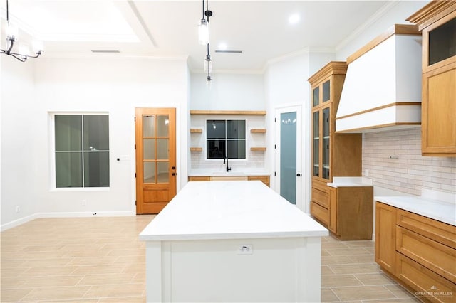 1808 Diplomat Dr, Edinburg, TX 78542 - kitchen with backsplash, crown molding, open shelves, light countertops, and glass insert cabinets