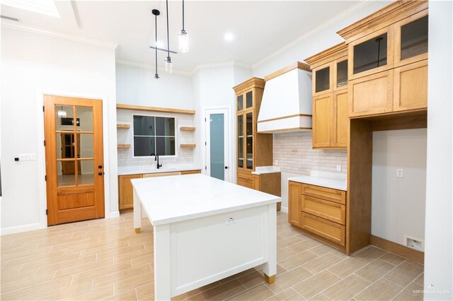 1808 Diplomat Dr, Edinburg, TX 78542 - kitchen featuring backsplash, open shelves, a center island, ornamental molding, and glass insert cabinets