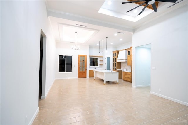 1808 Diplomat Dr, Edinburg, TX 78542 - unfurnished living room with a tray ceiling, ornamental molding, ceiling fan, a chandelier, and recessed lighting