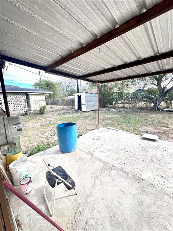 1210 SE Wright Ave SE, Pharr, TX 78577 - fenced backyard featuring a patio area and a storage unit