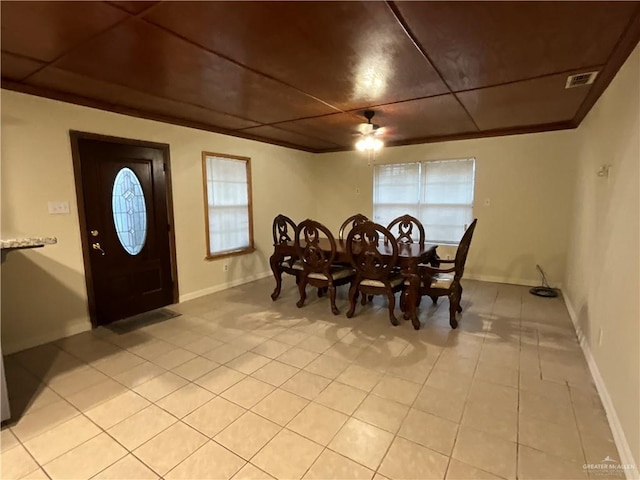 dining space with light tile patterned flooring, visible vents, and baseboards