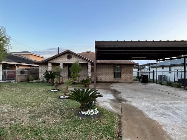 view of front of property with a gate, fence, a front lawn, and concrete driveway