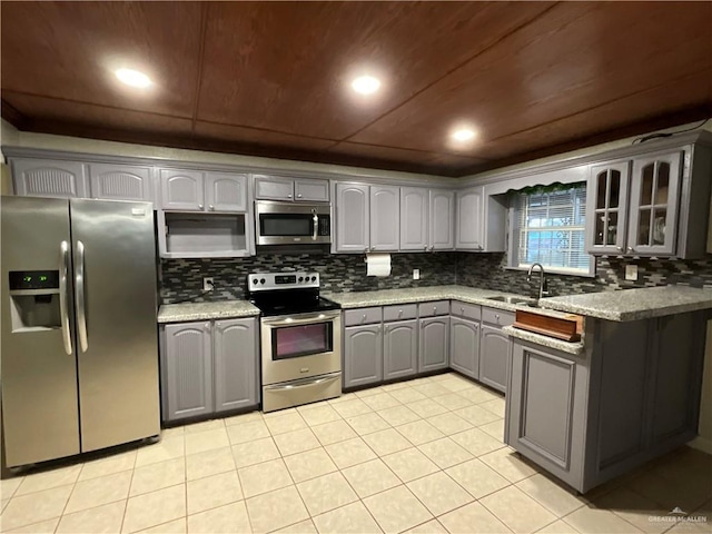 kitchen featuring wood ceiling, stainless steel appliances, glass insert cabinets, and gray cabinetry