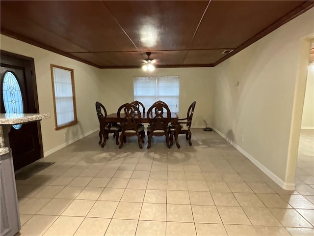 dining area featuring ornamental molding, baseboards, and light tile patterned floors