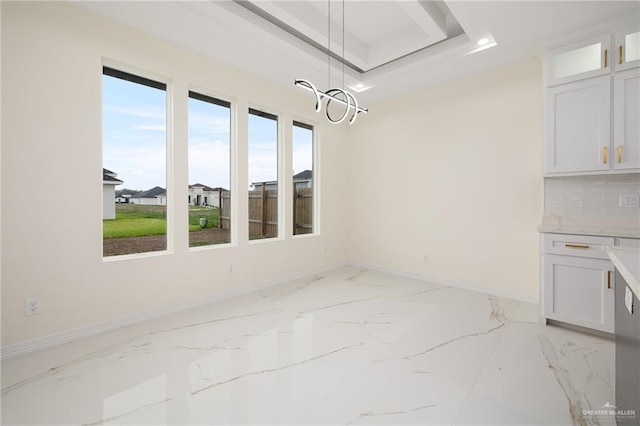 2809 E Tamarindo Ave, Hidalgo, TX 78557 - unfurnished dining area with light marble finish flooring, a chandelier, a tray ceiling, and recessed lighting