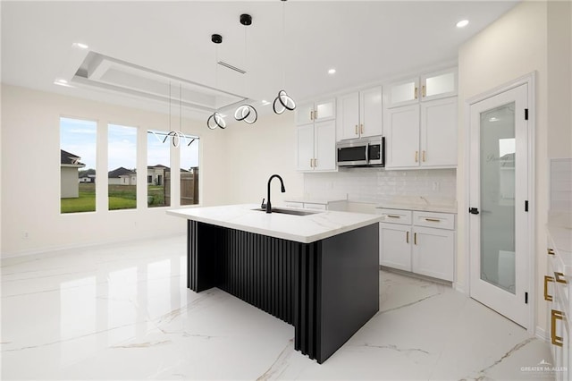 2809 E Tamarindo Ave, Hidalgo, TX 78557 - kitchen with stainless steel microwave, light marble finish floors, backsplash, white cabinets, and glass insert cabinets