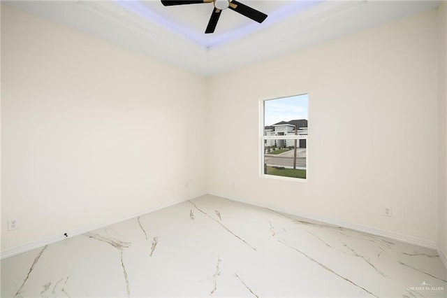 2809 E Tamarindo Ave, Hidalgo, TX 78557 - unfurnished room featuring light marble finish floors, a ceiling fan, and a tray ceiling