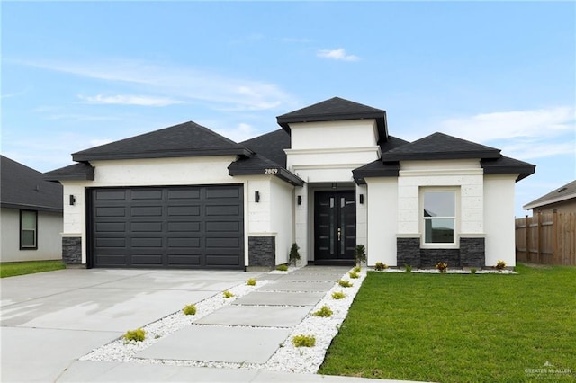 2809 E Tamarindo Ave, Hidalgo, TX 78557 - view of front of property with a garage, driveway, stone siding, french doors, and stucco siding
