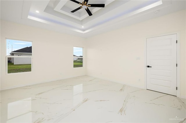 2809 E Tamarindo Ave, Hidalgo, TX 78557 - unfurnished room with a tray ceiling, healthy amount of natural light, light marble finish flooring, and recessed lighting