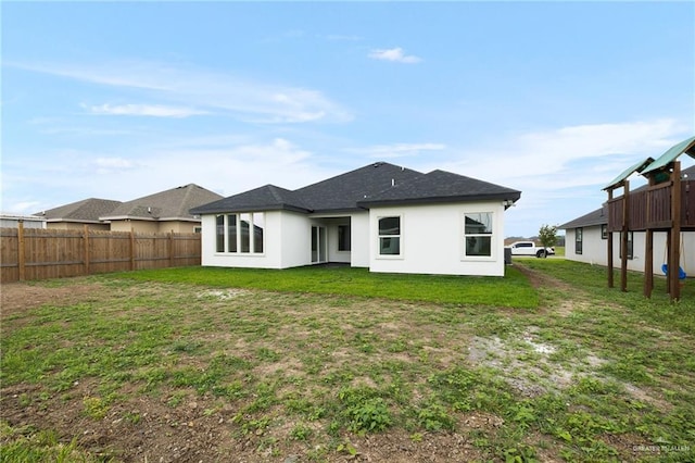 2809 E Tamarindo Ave, Hidalgo, TX 78557 - rear view of house featuring stucco siding and roof with shingles