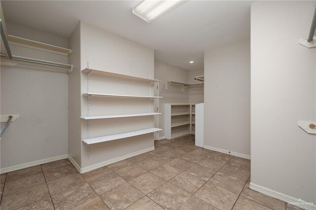 spacious closet with tile patterned floors