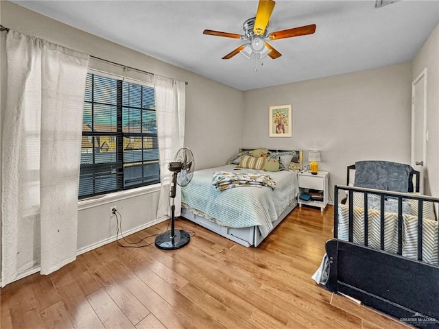 bedroom featuring ceiling fan and light hardwood / wood-style flooring