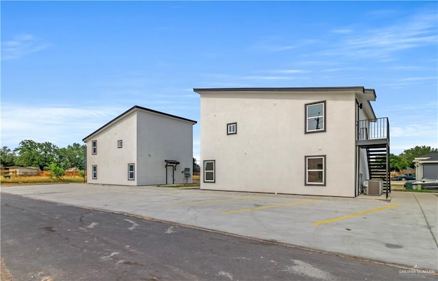 back of property featuring central AC unit