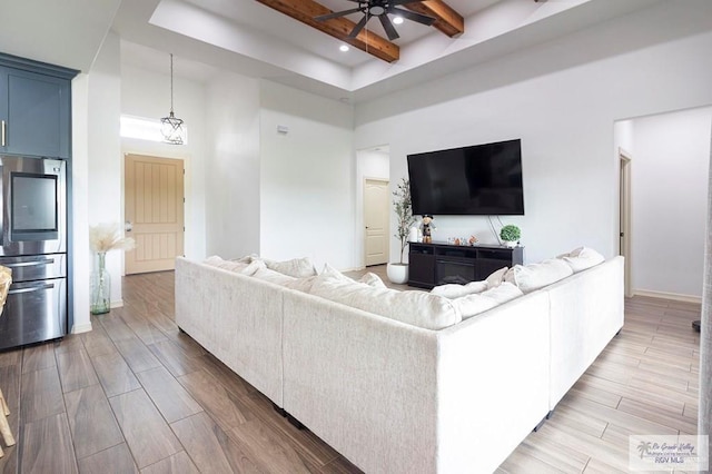 9753 Lake Arthur Ct, Los Fresnos, TX 78566 - living area with ceiling fan, beam ceiling, a high ceiling, wood finished floors, and recessed lighting