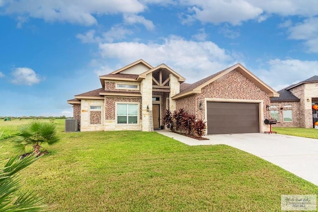 9753 Lake Arthur Ct, Los Fresnos, TX 78566 - view of front of home with an attached garage, driveway, stone siding, a front yard, and brick siding