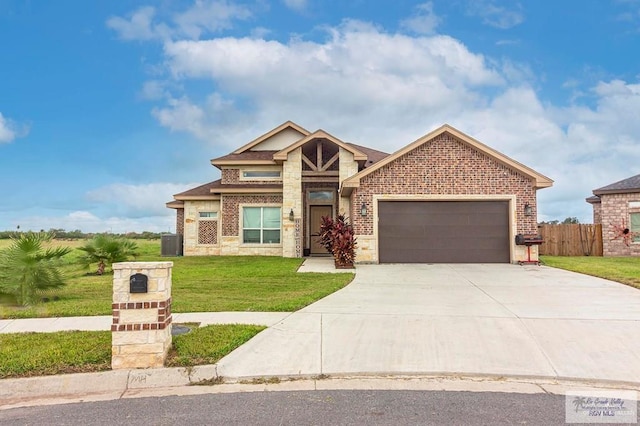 9753 Lake Arthur Ct, Los Fresnos, TX 78566 - view of front of property featuring stone siding, an attached garage, concrete driveway, and brick siding