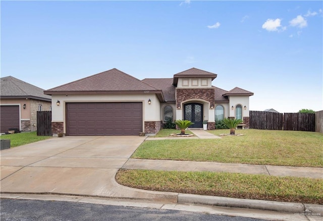 view of front of house featuring french doors, a garage, and a front lawn