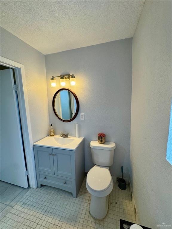 3813 N Taylor Rd, Mission, TX 78573 - bathroom featuring a textured wall, vanity, tile patterned floors, and a textured ceiling