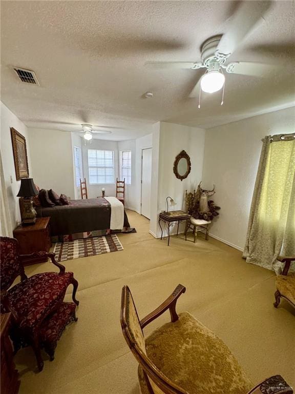 3813 N Taylor Rd, Mission, TX 78573 - bedroom featuring a textured ceiling, light colored carpet, and a ceiling fan