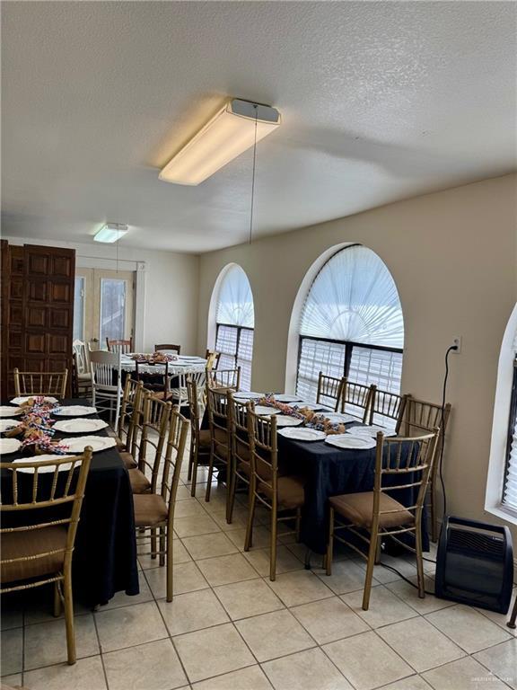 3813 N Taylor Rd, Mission, TX 78573 - dining space with light tile patterned flooring and a textured ceiling
