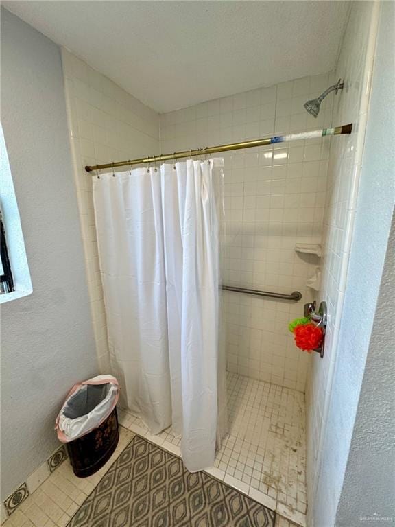 3813 N Taylor Rd, Mission, TX 78573 - full bathroom with a tile shower, tile patterned flooring, and a textured wall