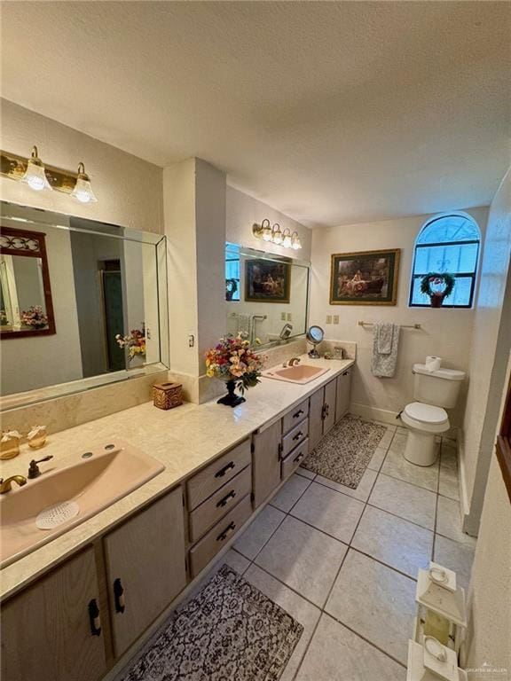 3813 N Taylor Rd, Mission, TX 78573 - bathroom featuring a textured ceiling, double vanity, and tile patterned floors