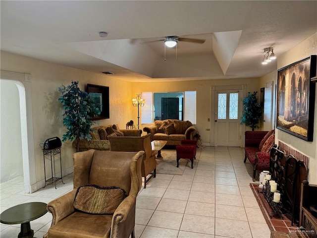 3813 N Taylor Rd, Mission, TX 78573 - living room featuring light tile patterned flooring, ceiling fan, a raised ceiling, and arched walkways
