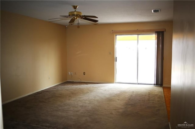 carpeted spare room featuring ceiling fan