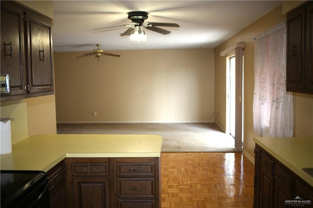 kitchen featuring dark brown cabinets, ceiling fan, black range with electric stovetop, and light parquet flooring