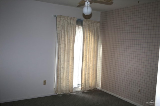 carpeted spare room featuring ceiling fan