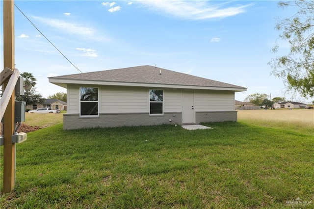 rear view of house with a yard