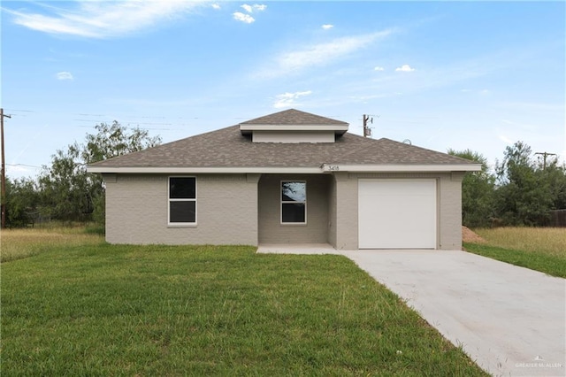 view of front of house with a garage and a front lawn