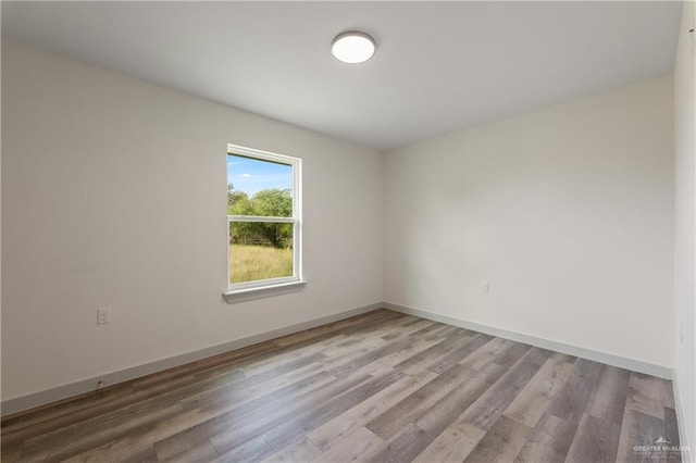 unfurnished room featuring wood-type flooring