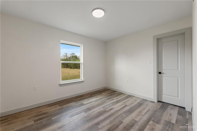 spare room with light hardwood / wood-style floors