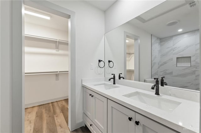 bathroom with hardwood / wood-style floors, vanity, and toilet