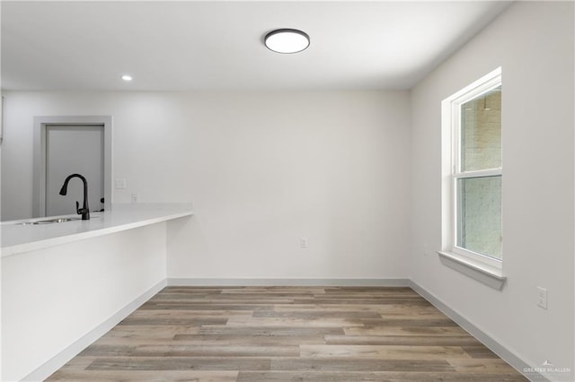 interior space with light hardwood / wood-style floors and sink