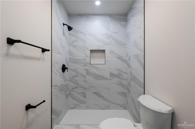 bathroom with tiled shower and toilet