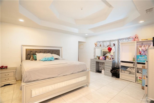 tiled bedroom with a tray ceiling