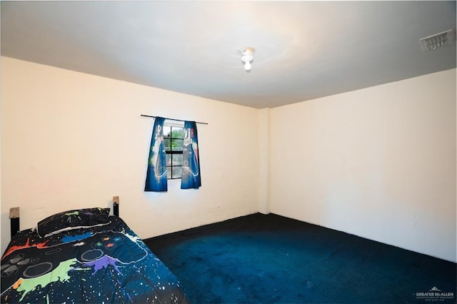 bedroom with dark colored carpet