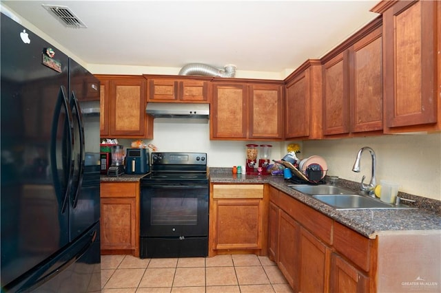 kitchen featuring light tile patterned flooring, sink, and black appliances