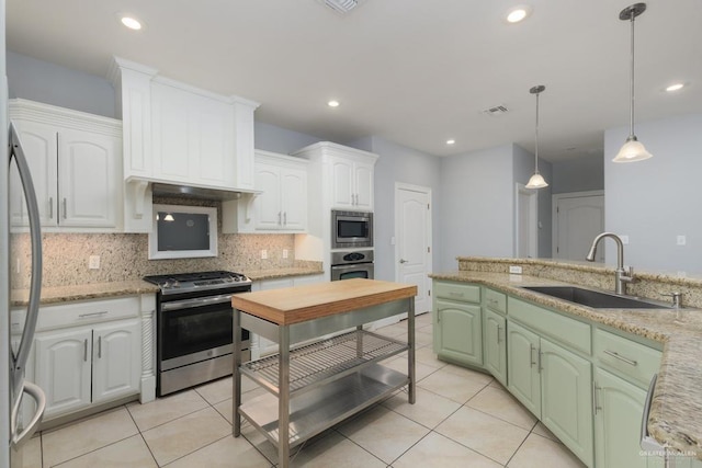 3222 Princess St, Edinburg, TX 78539 - kitchen with appliances with stainless steel finishes, a sink, white cabinets, tasteful backsplash, and light tile patterned flooring