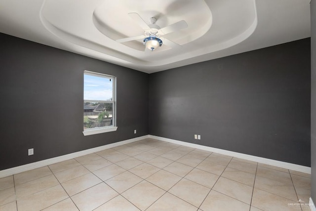 3222 Princess St, Edinburg, TX 78539 - empty room featuring ceiling fan, a tray ceiling, light tile patterned floors, and baseboards