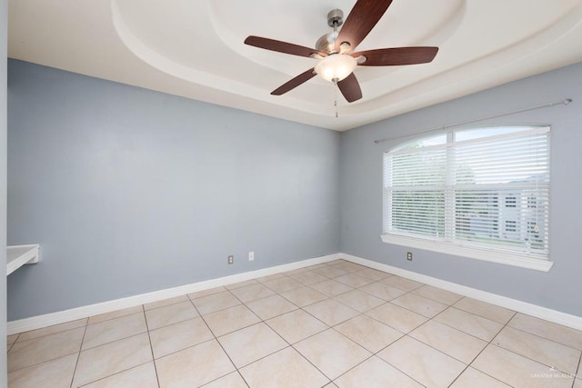 3222 Princess St, Edinburg, TX 78539 - spare room with a tray ceiling, ceiling fan, light tile patterned floors, and baseboards
