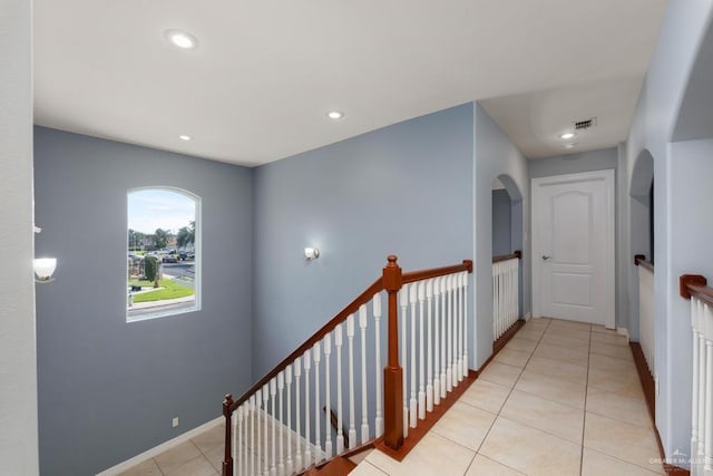 3222 Princess St, Edinburg, TX 78539 - hallway with light tile patterned flooring, recessed lighting, an upstairs landing, arched walkways, and baseboards