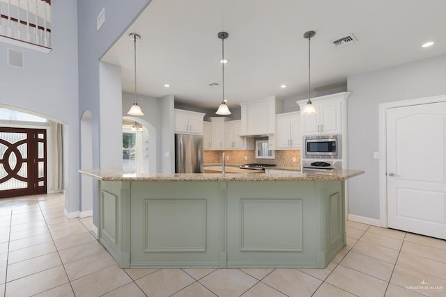3222 Princess St, Edinburg, TX 78539 - kitchen featuring stainless steel appliances, light tile patterned flooring, white cabinetry, backsplash, and recessed lighting